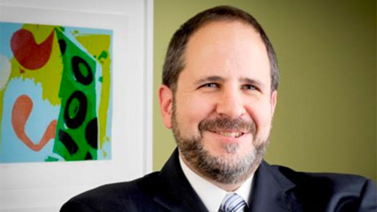 Photo of Al Elia in a suit and tie